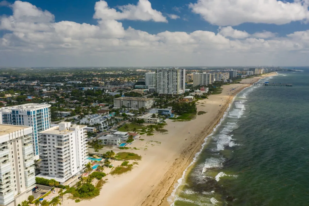 Aerial view of the Pompano Beach coastline with turquoise water and beachfront towers