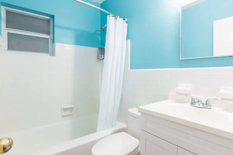 Turquoise bathroom with tub and vanity