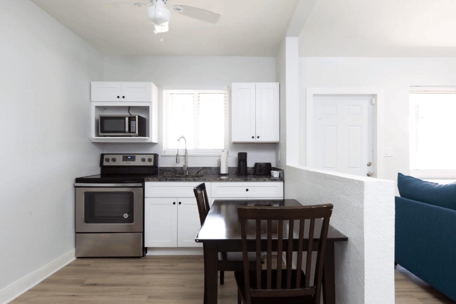 Suite kitchen with microwave, stove and dining table