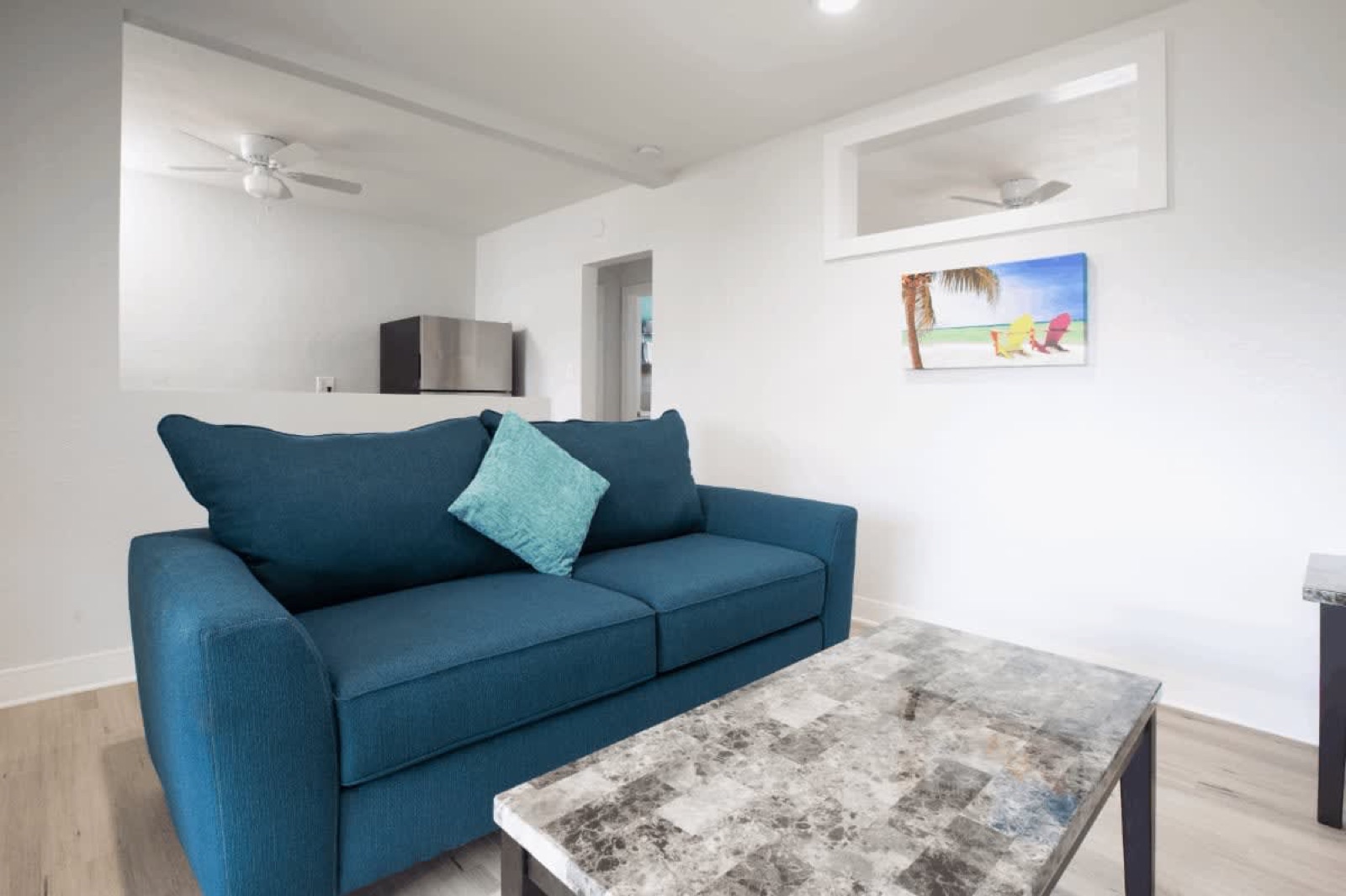 Blue sofa living room with beach art, Pompano Beach, FL