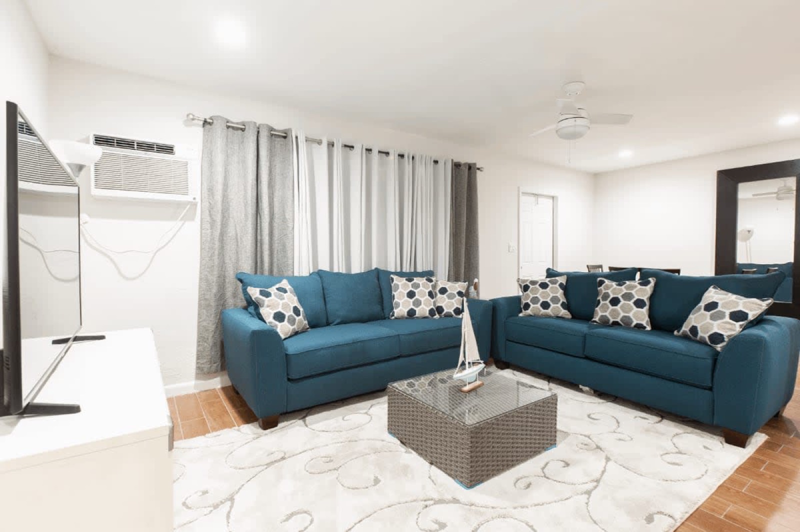 Suite living room with two blue sofas at Pompano Breeze