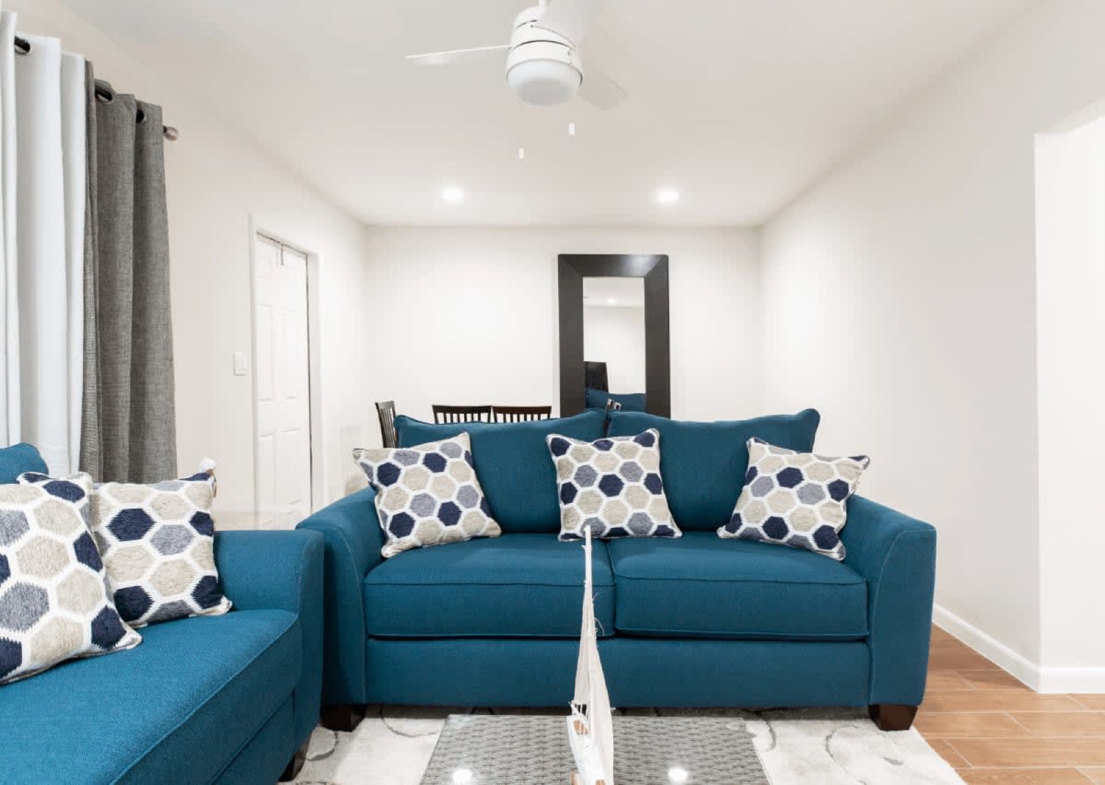Suite living room with two blue sofas and patterned pillows