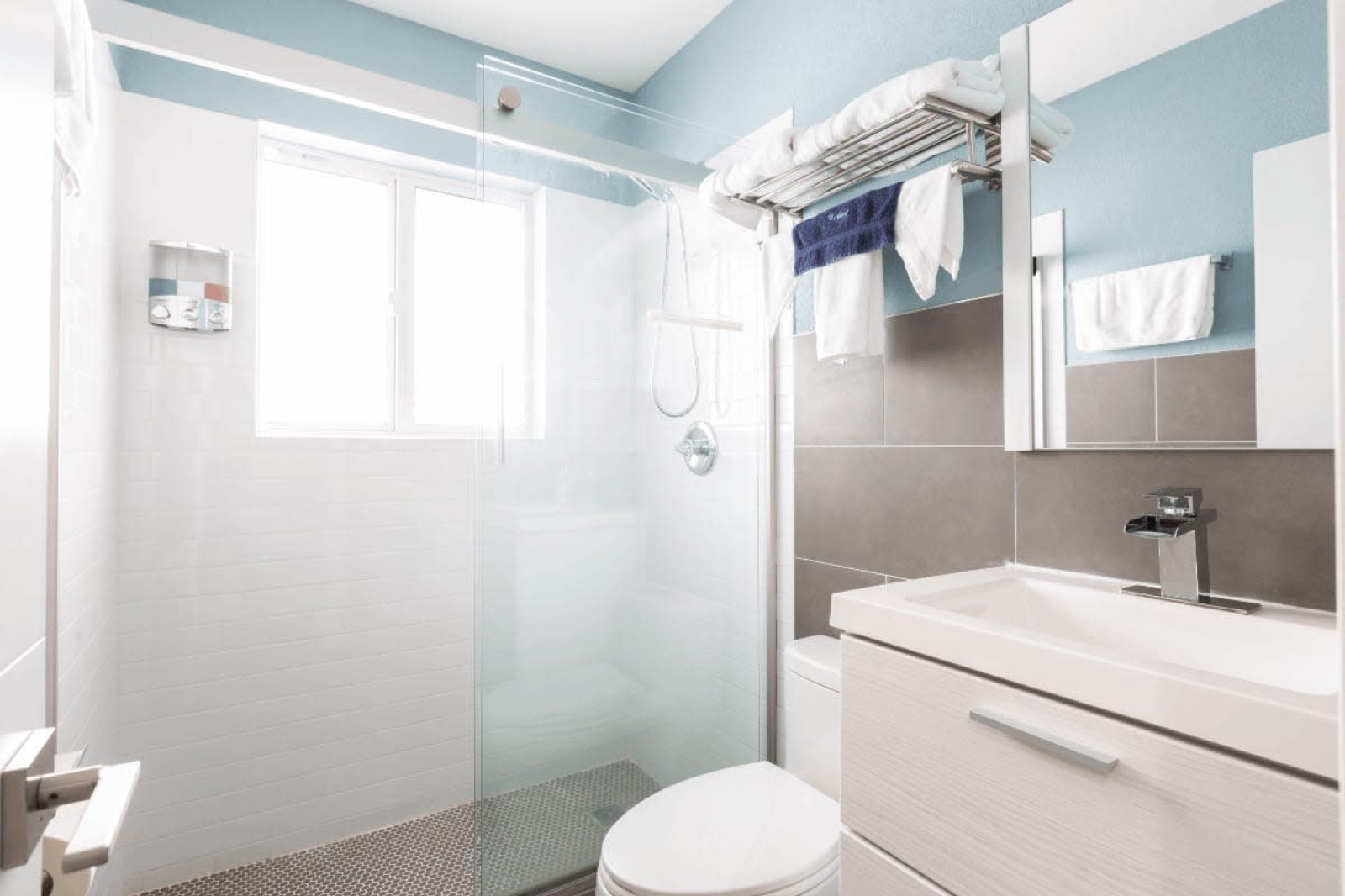 Glass walk-in shower and vanity at Pompano Breeze, Pompano Beach