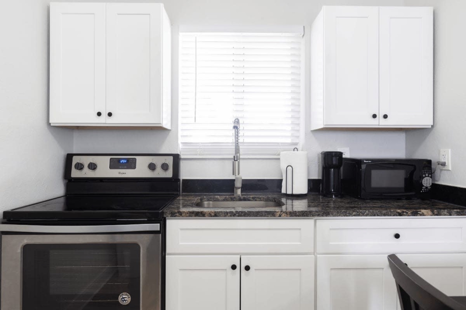 Kitchen with stainless stove and microwave at Pompano Breeze, Pompano Beach