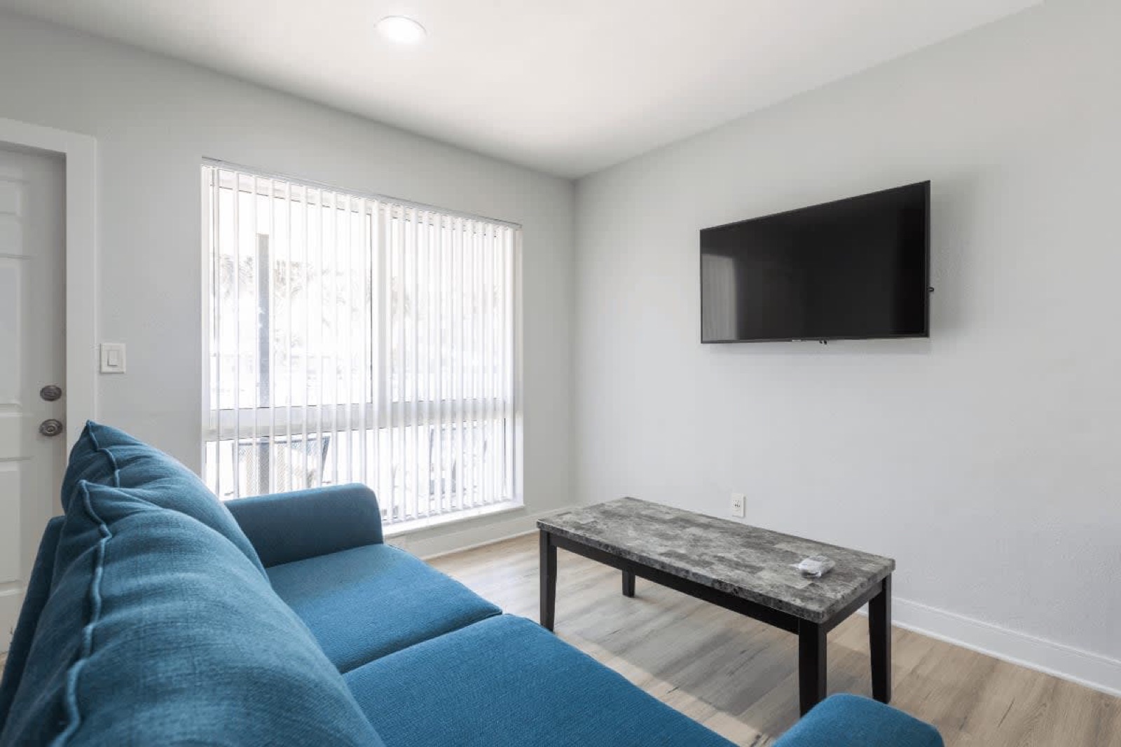 Living room sofa, coffee table and TV at Pompano Breeze, Pompano Beach