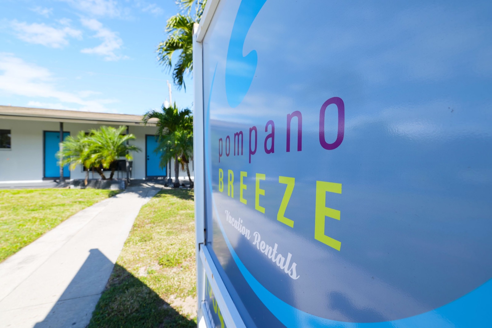 Pompano Breeze sign beside the walkway to the units