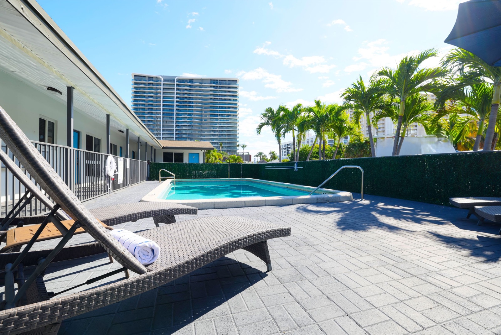 Pool deck loungers with tower behind at Pompano Breeze, Pompano Beach