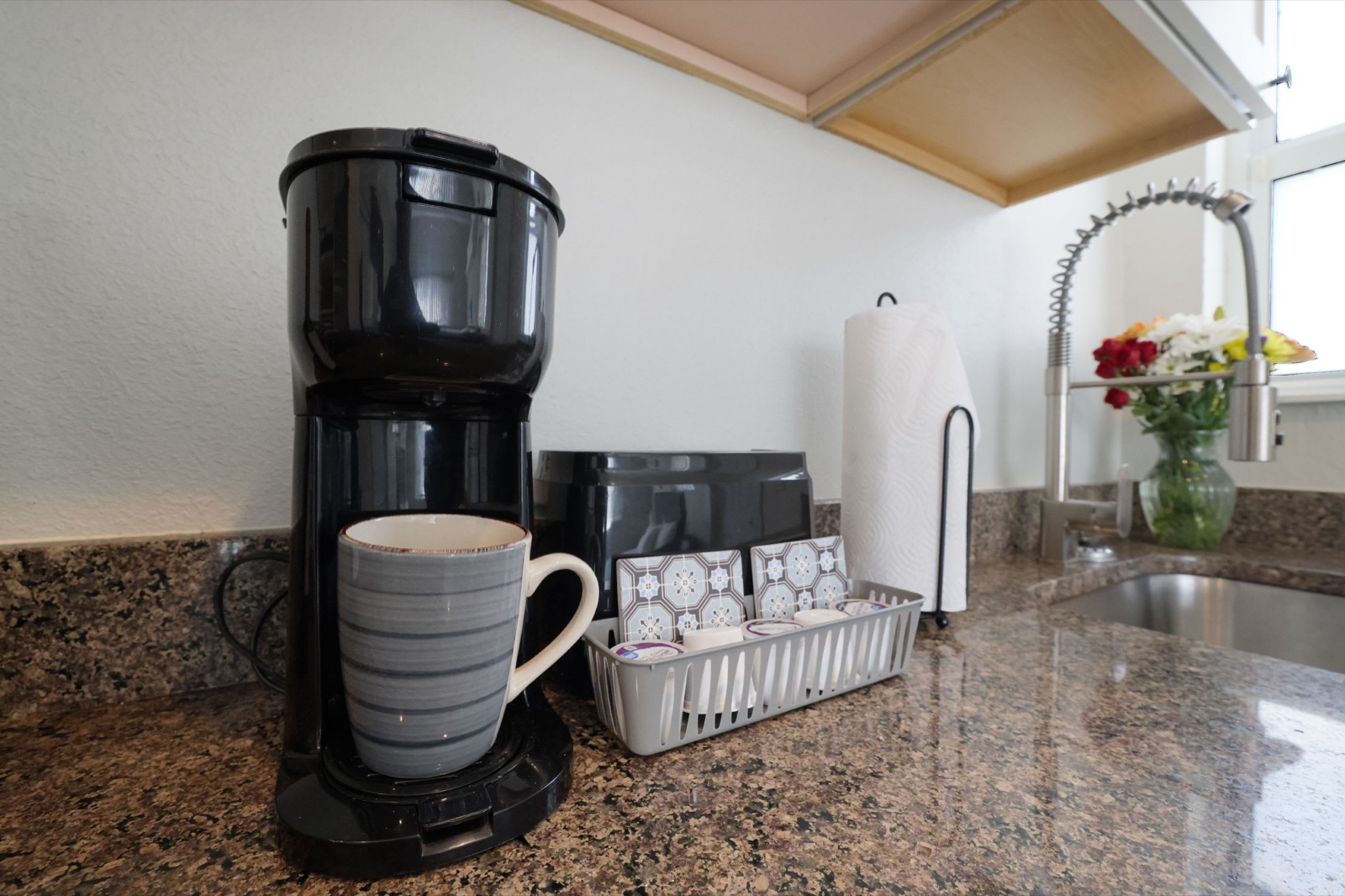 Coffee maker and mug on granite counter at Pompano Breeze, Pompano Beach